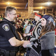 AbbyPD Officer shakes the hand of one of the Indigenous Role Models